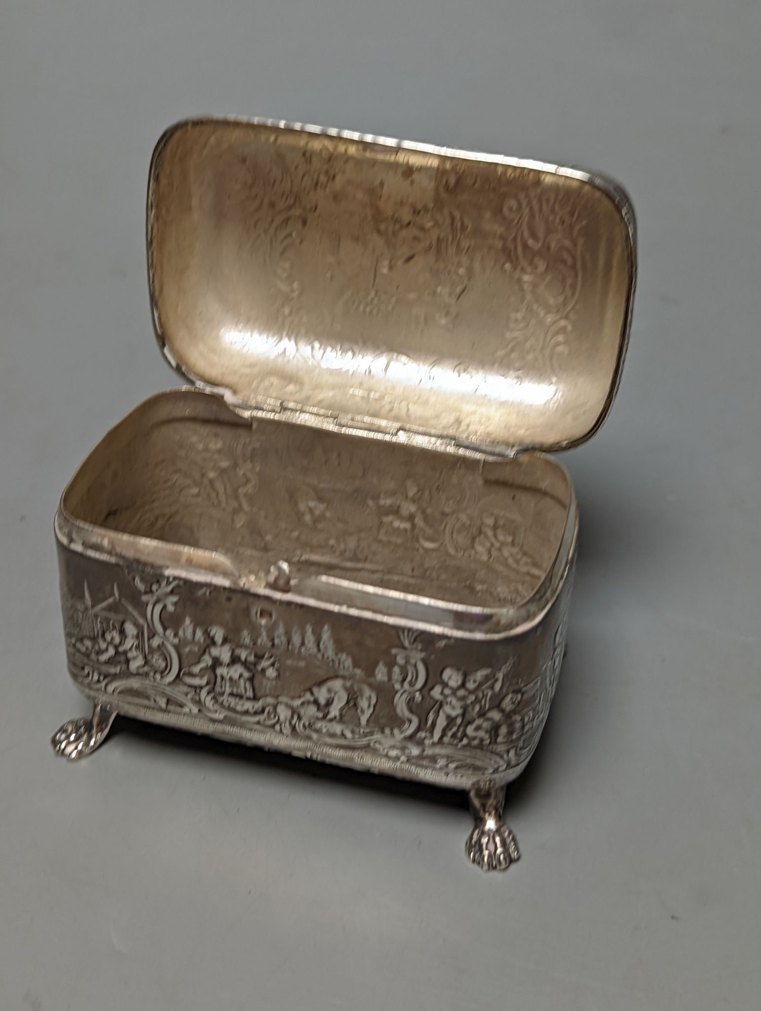 An Edwardian repousse silver mounted photograph frame, Birmingham, 1901, 15.8cm and a small white metal casket.
